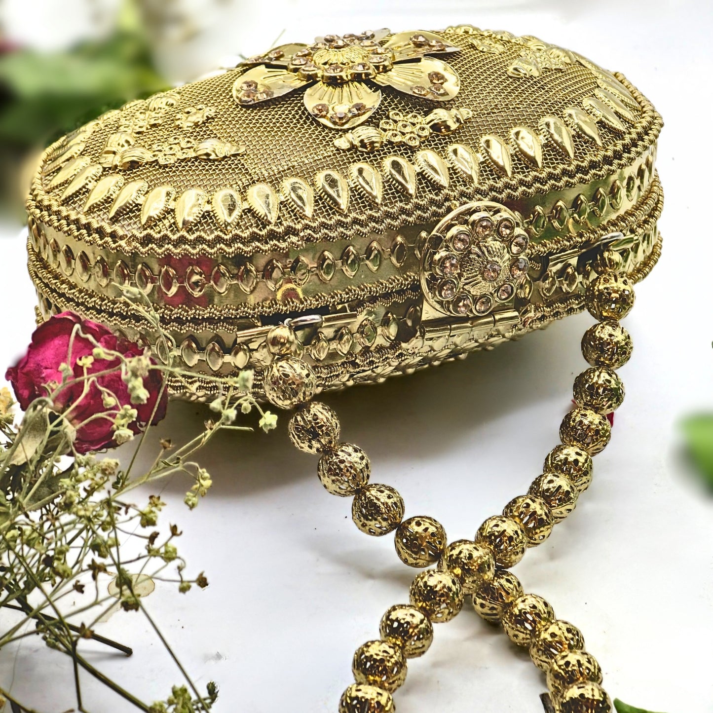 Get ready to add a touch of glamour to your outfit with this golden vintage beauty all the way from Patiala, India! Featuring intricate ethnic gold carvings, bright yellow stones on the clasp, and a stunning floral motif, this hand-crafted mini bag is the perfect accessory for any occasion. Don't miss out on the finesse of Indian artisans with this elegant piece.