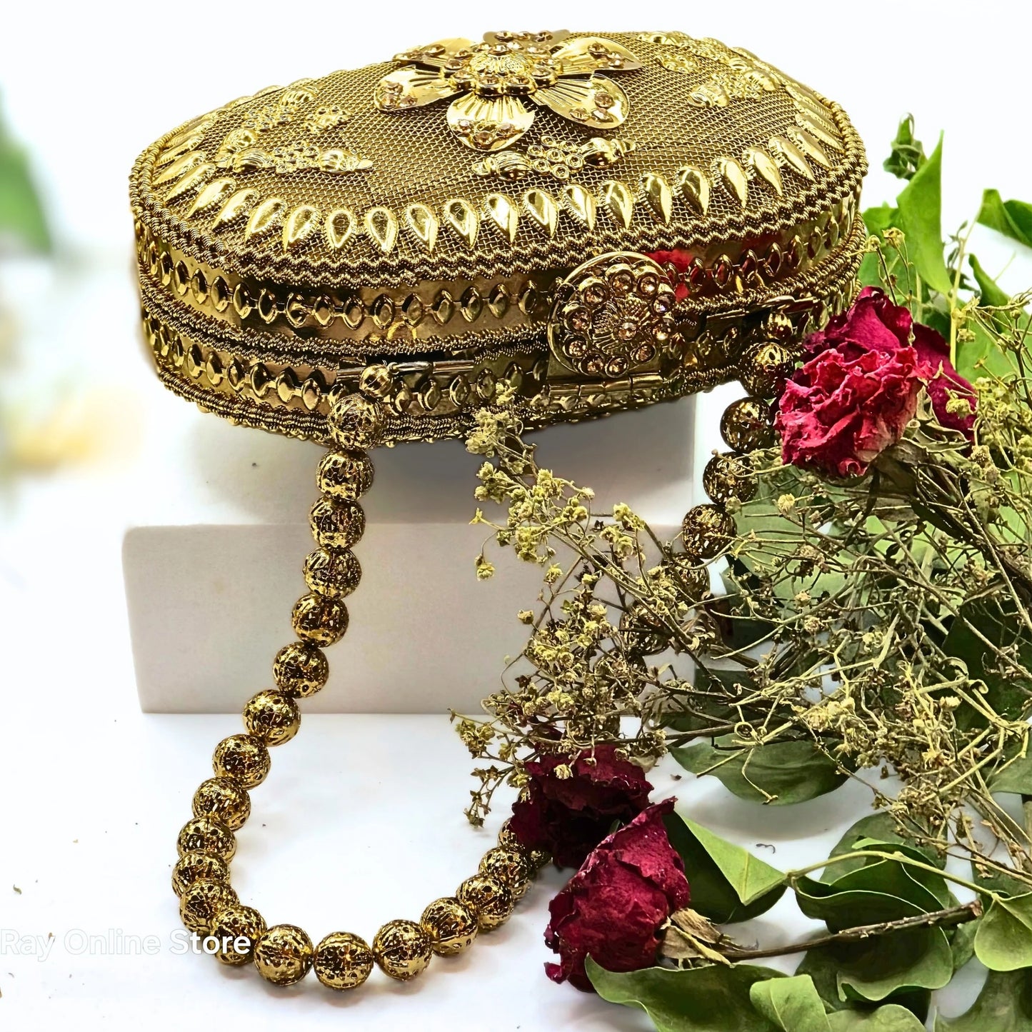 Get ready to add a touch of glamour to your outfit with this golden vintage beauty all the way from Patiala, India! Featuring intricate ethnic gold carvings, bright yellow stones on the clasp, and a stunning floral motif, this hand-crafted mini bag is the perfect accessory for any occasion. Don't miss out on the finesse of Indian artisans with this elegant piece.