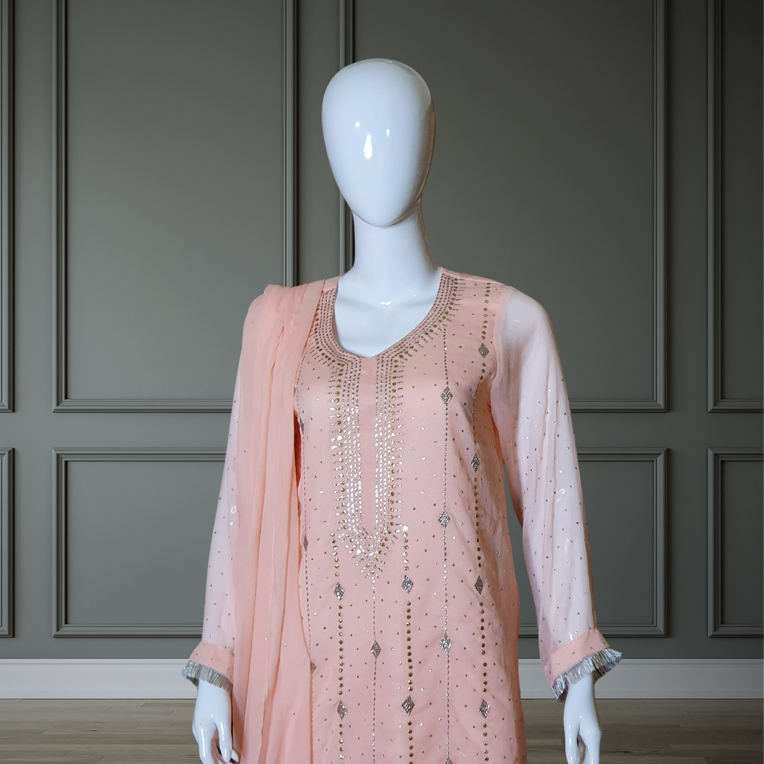 Peach Classic Mukesh Outfit - 3PC. Features intricate gold and silver embroidery on the neckline, soft chiffon shirt, silk Plazzo with gota details, and finished dupatta with Mukesh and lace. Sleeves also adorned for a cohesive look. Perfect for any festive occasion.