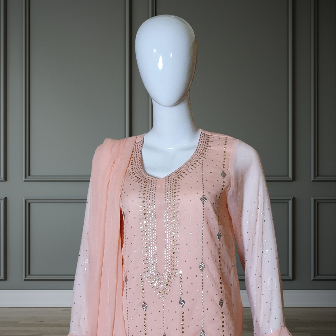 Peach Classic Mukesh Outfit - 3PC. Features intricate gold and silver embroidery on the neckline, soft chiffon shirt, silk Plazzo with gota details, and finished dupatta with Mukesh and lace. Sleeves also adorned for a cohesive look. Perfect for any festive occasion.