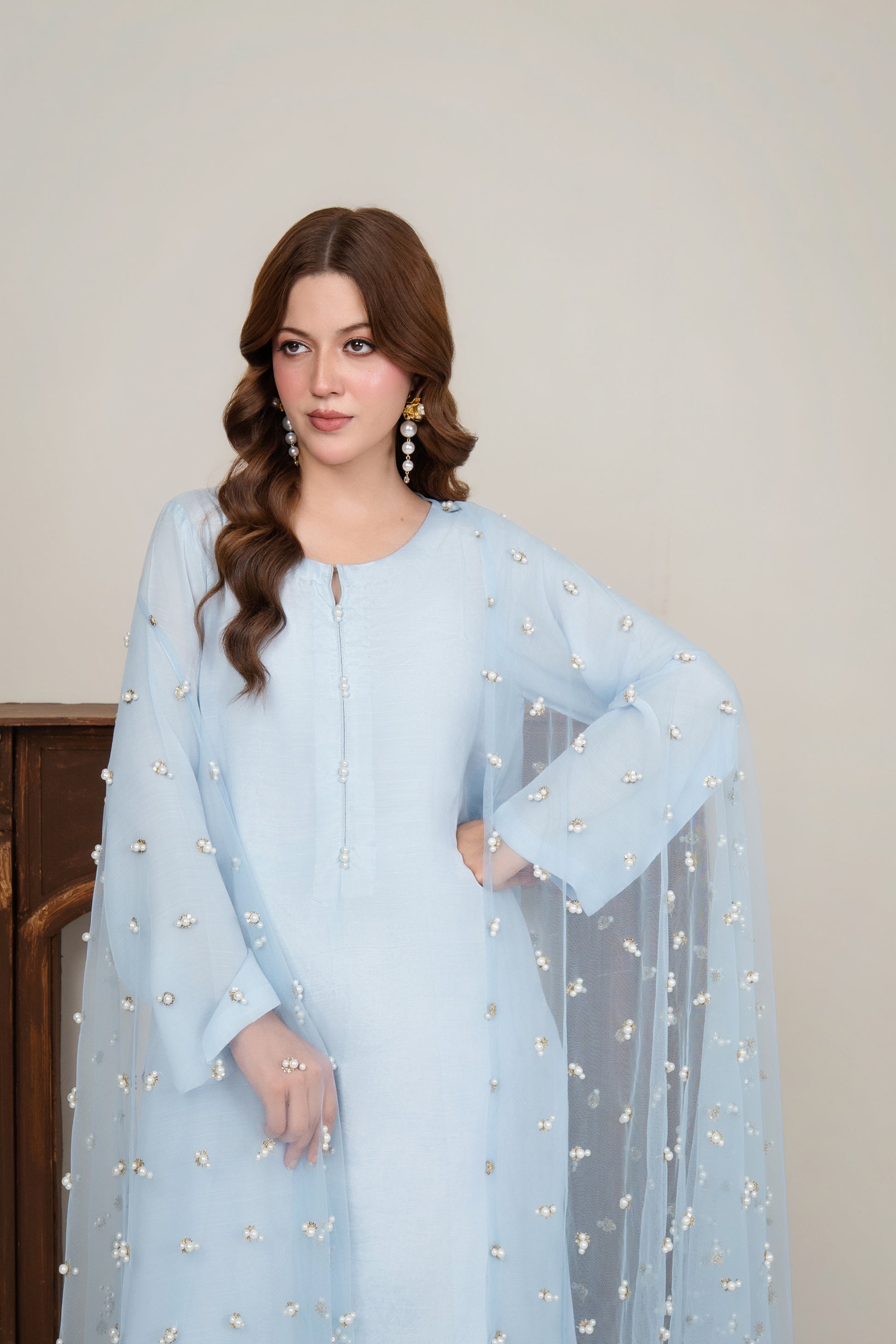 close shot of the net dupatta, focusing on the hand-embellished punched pearls for a secure and high-quality finish on the sheer fabric.
