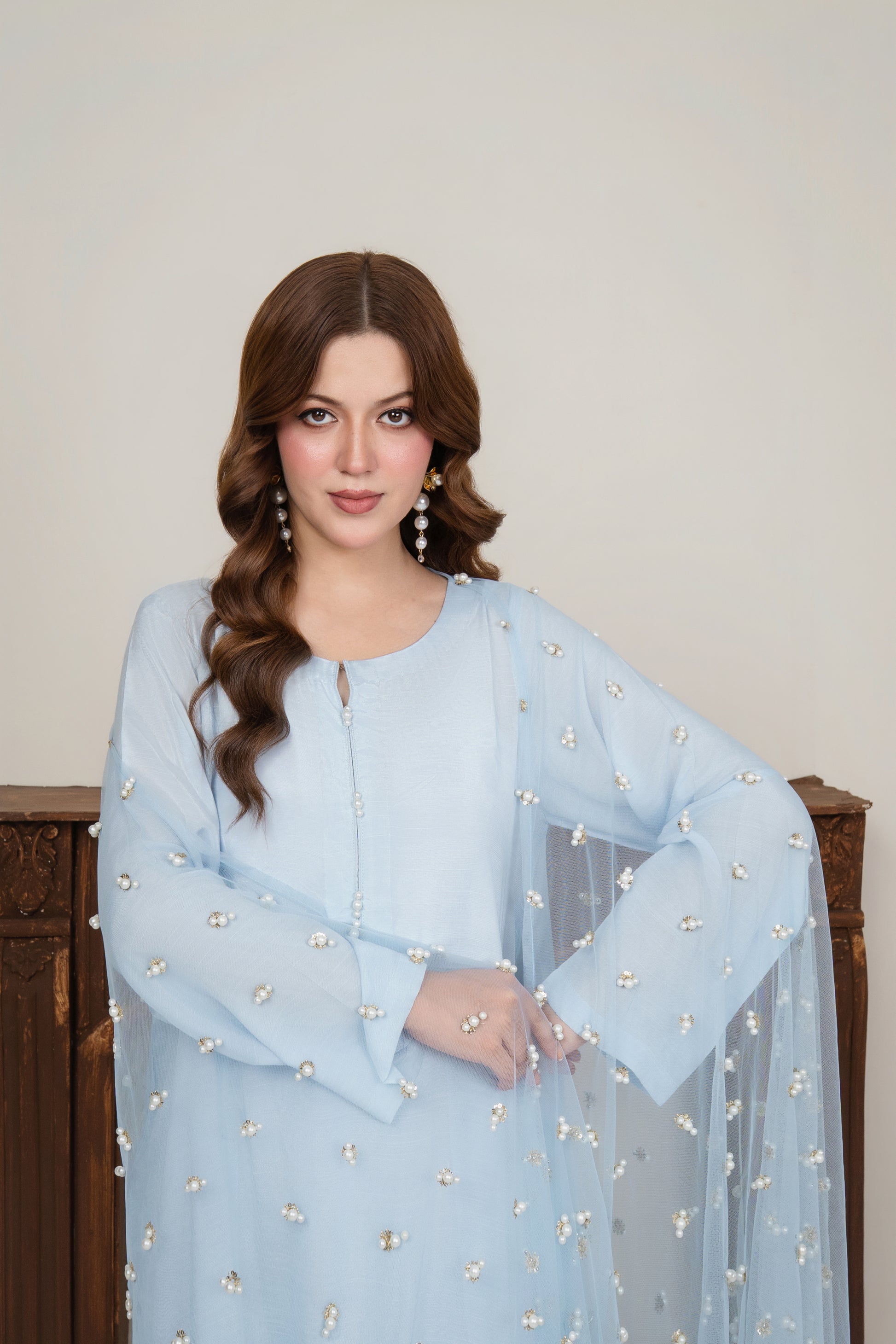 Close-up of the long kurta's neckline, showing intricate pearl embroidery on premium ice blue raw silk fabric.