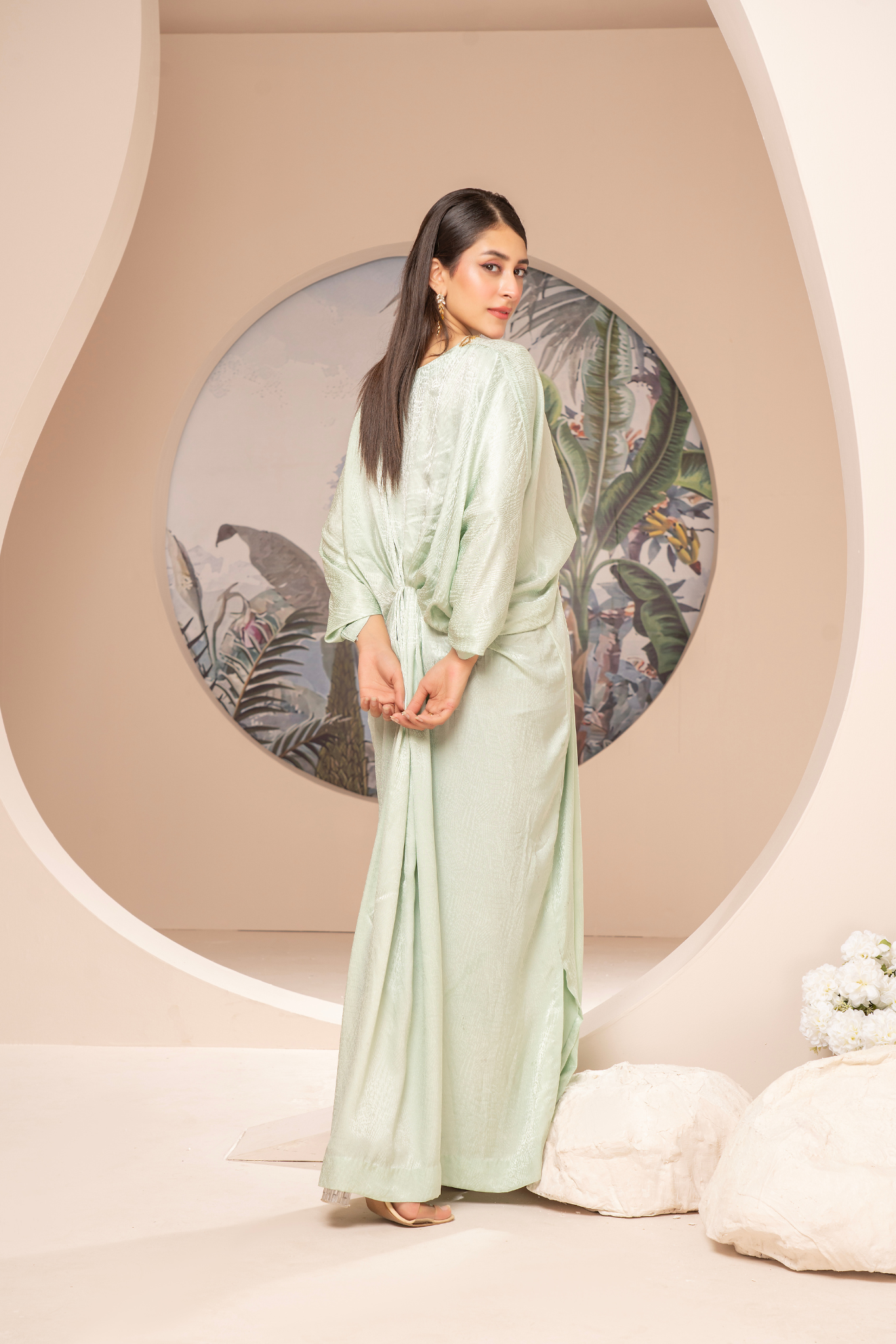 Elegant mint-green long dress from the Kanza Collection, featuring a draped silhouette with intricate gold embellishments at the waist, perfect for semi-formal or formal events.