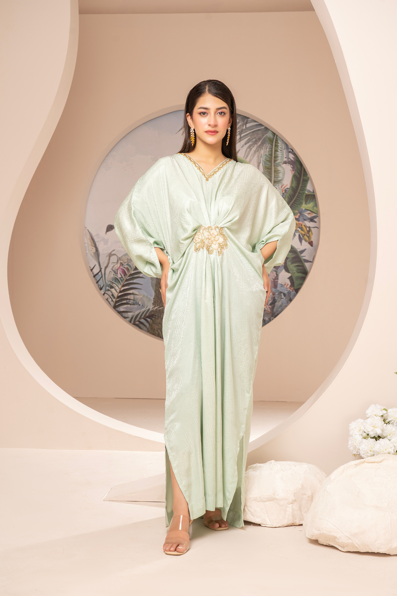 Elegant mint-green long dress from the Kanza Collection, featuring a draped silhouette with intricate gold embellishments at the waist, perfect for semi-formal or formal events.