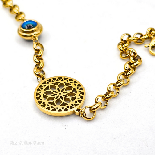 Gold-plated filigree bracelet with an evil eye charm, crafted from stainless steel with an adjustable link chain.
