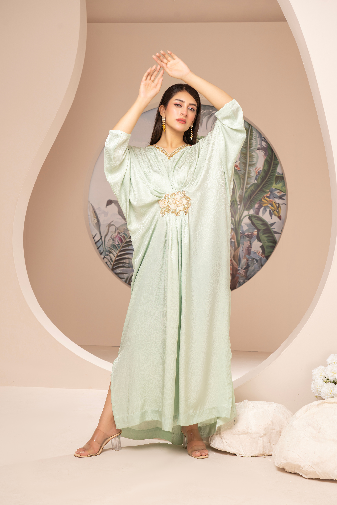 Elegant mint-green long dress from the Kanza Collection, featuring a draped silhouette with intricate gold embellishments at the waist, perfect for semi-formal or formal events.