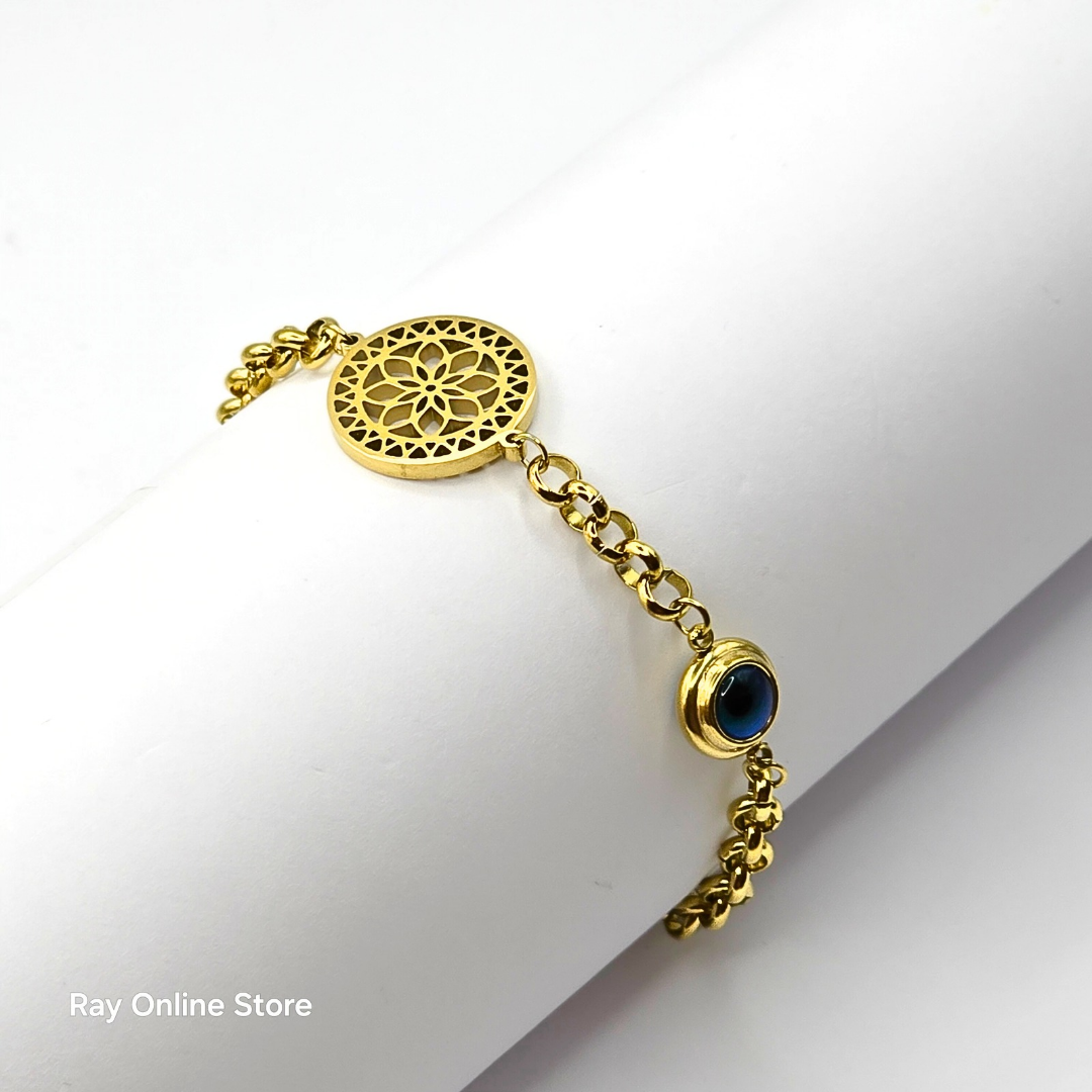 Gold-plated filigree bracelet with an evil eye charm, crafted from stainless steel with an adjustable link chain.
