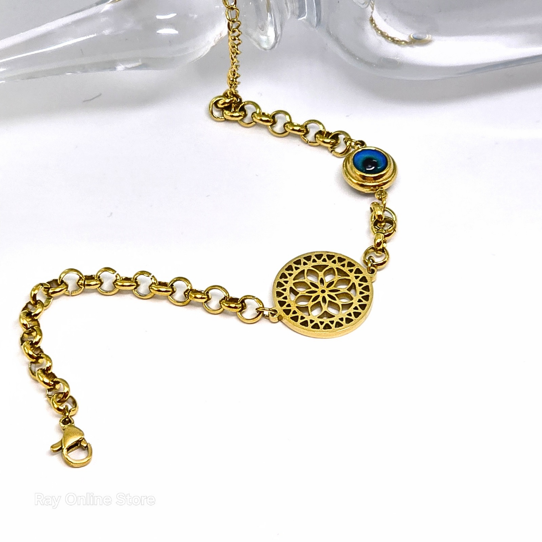 Gold-plated filigree bracelet with an evil eye charm, crafted from stainless steel with an adjustable link chain.
